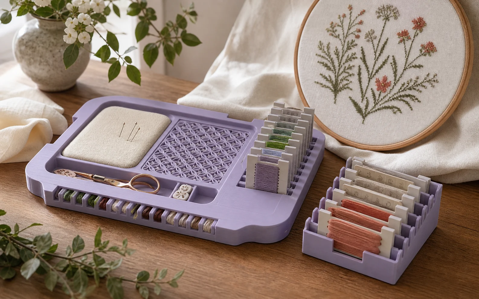 A fitted cross-stitch workstation with thread cards and tools.